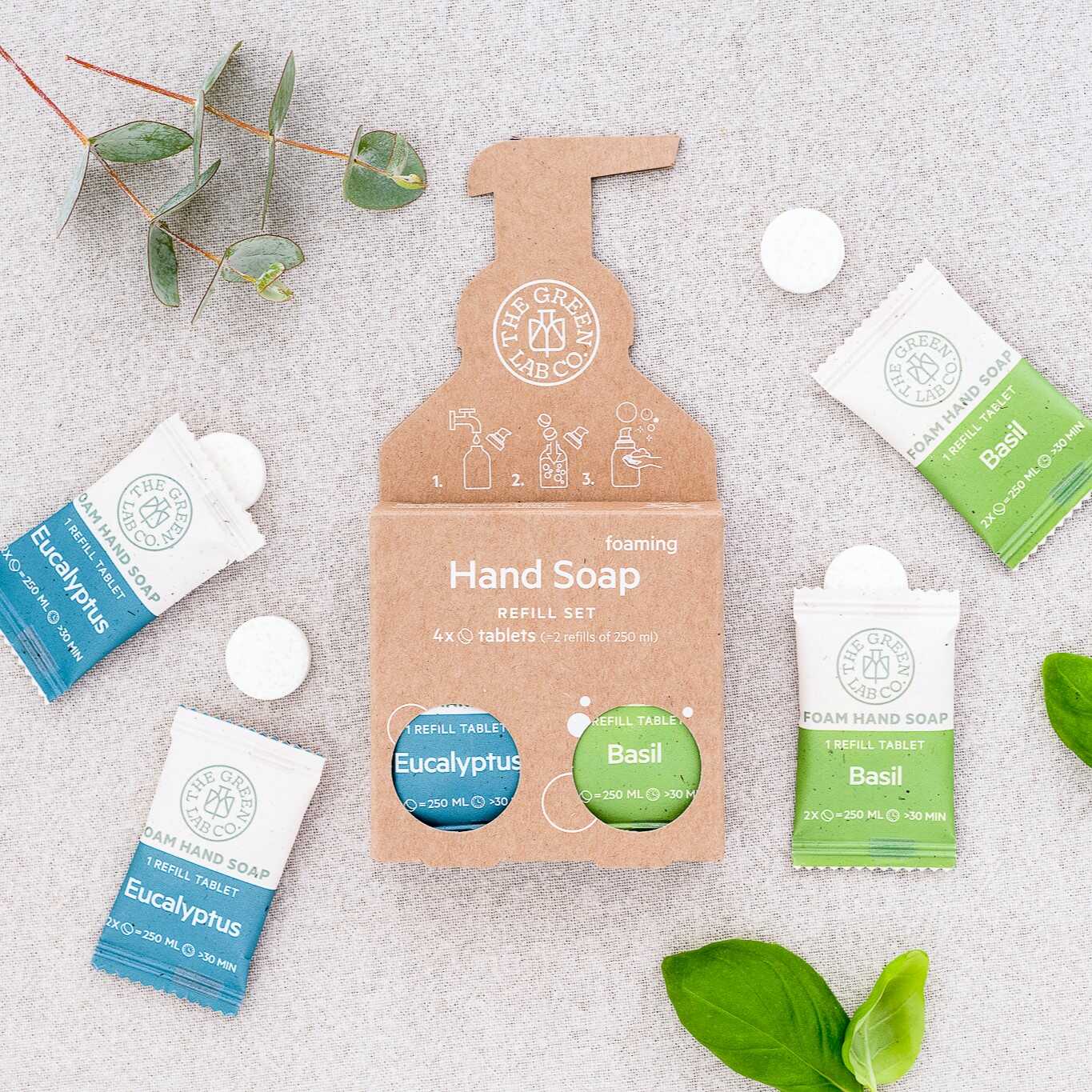 The Green Lab Co foaming hand soap refill set—Eucalyptus & Basil tablets on a light fabric background.